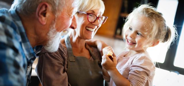 Grandparents and granddaughter eating together